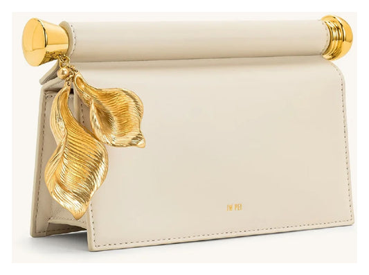 Angled side view of JW Pei Holly cream embellished clutch with structured profile and gold-tone leaf pendant.