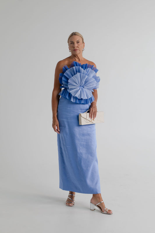 Aje Kira blue strapless midi dress with sculptural pleated frills, styled with the JW Pei Celeste cream woven top handle bag.