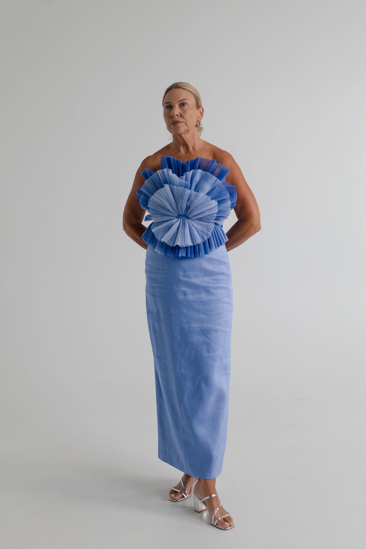 Aje Kira blue strapless corset midi dress with dramatic pleated frill bodice and straight column skirt.