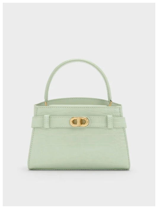 Charles & Keith Aubrielle mint croc-effect belted top handle bag with gold-tone hardware, front view. 