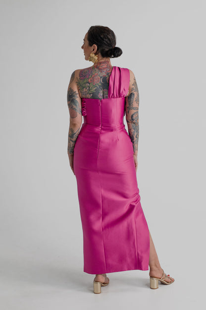 Back view of the Eliya the Label Renata magenta one-shoulder midi dress showing the fitted silhouette, asymmetric shoulder strap and centre-back zip.
