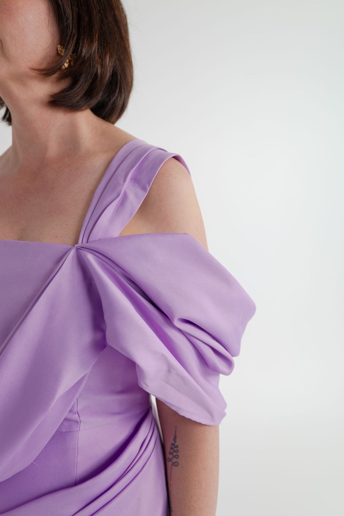 Close-up of the Eliya the Label Scarlett lilac dress showing the sculptural one-shoulder fold and softly draped bodice detailing.
