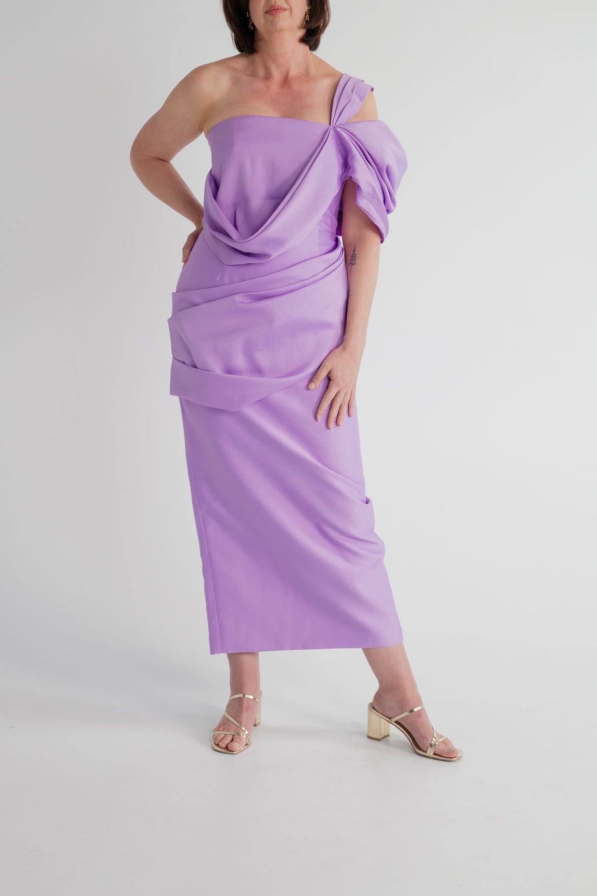 Eliya the Label Scarlett lilac one-shoulder midi dress with sculptural draped bodice, fitted column silhouette and layered skirt detailing.
