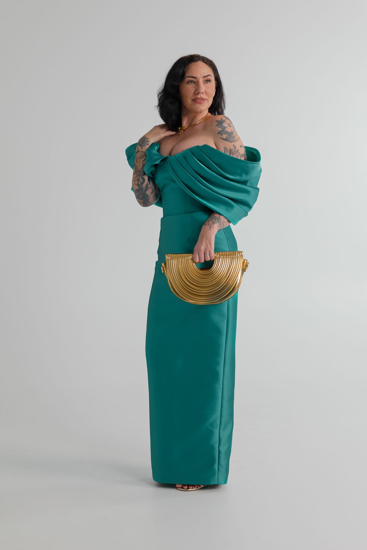 Eliya the Label Vera teal off-the-shoulder midi dress styled with the Verano Hill Amara gold metallic handbag.
