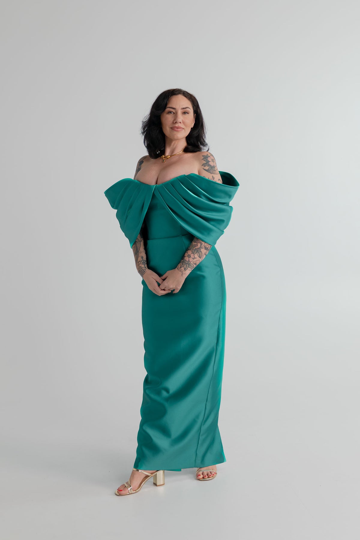 Eliya the Label Vera teal off-the-shoulder midi dress with sculptural draped neckline and fitted silhouette.

