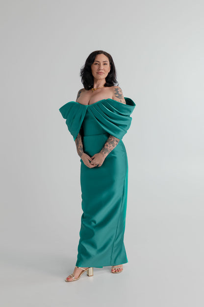 Eliya the Label Vera teal off-the-shoulder midi dress with sculptural draped neckline and fitted silhouette.
