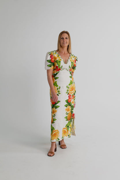 Farm Rio Picnic Flowers Off-White Maxi dress with colourful tropical fruit and floral print, puff sleeves and a deep V neckline, shown full length from the front.

