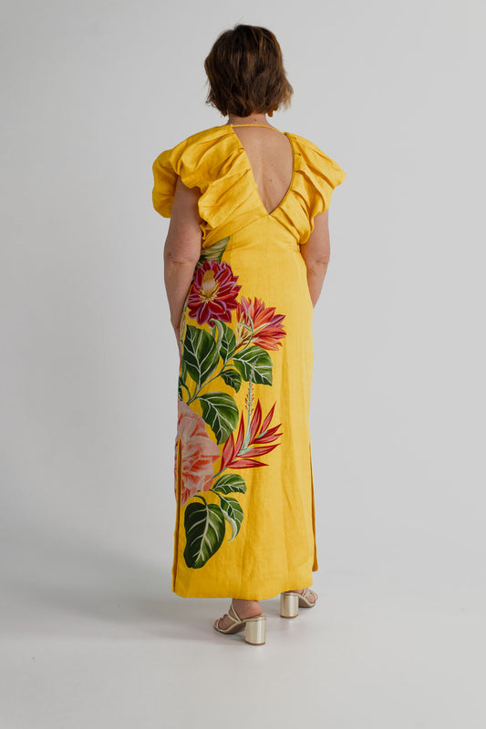 Back view of the Farm Rio Spring Awakening Midi showing the V-back, sculptural ruffle shoulders and tropical floral placement print.
