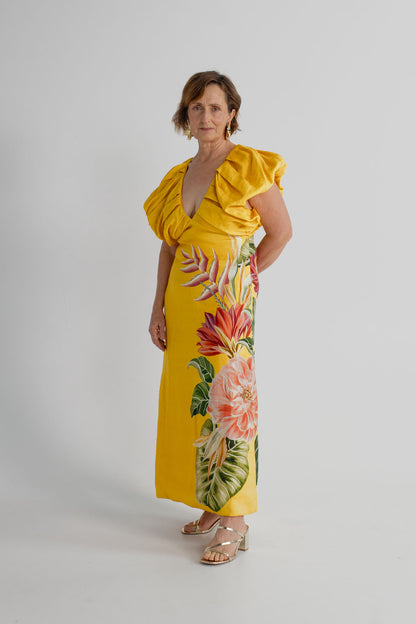 Farm Rio Spring Awakening Midi dress in yellow with tropical floral placement print, deep V neckline and sculptural ruffle sleeves, shown full length from the front.
