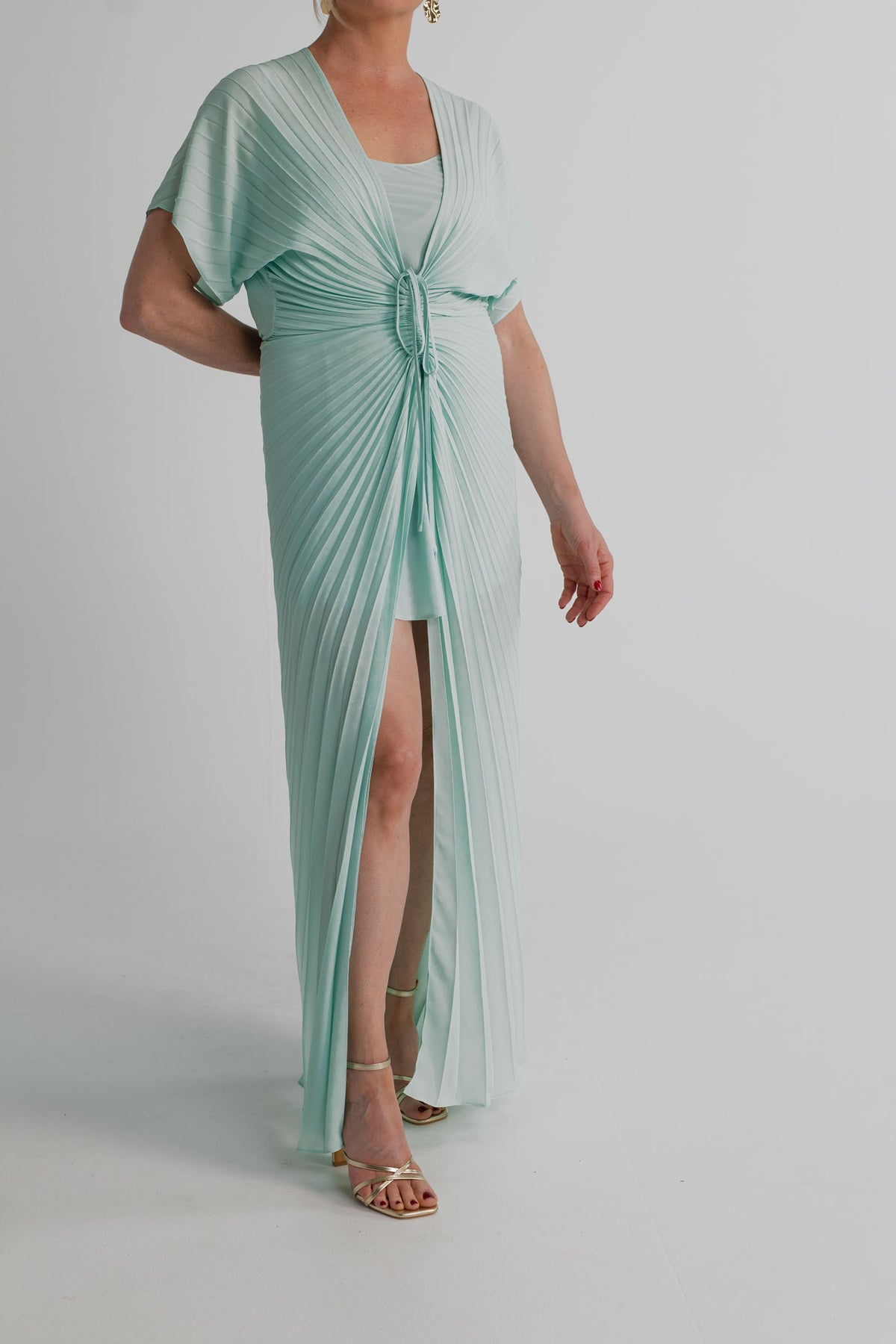 Georgia Hardinge Illusion mint kaftan showing the sunray pleating, deep V neckline, adjustable gathered waist and sheer flowing outer layer.
