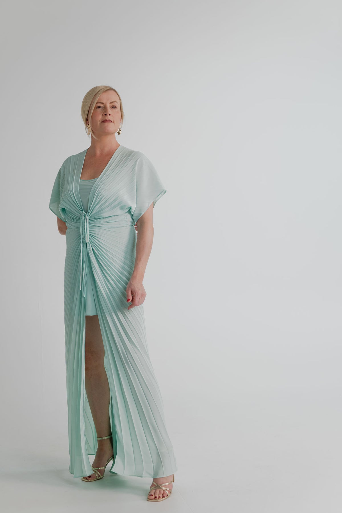 Georgia Hardinge Illusion mint pleated kaftan maxi dress with deep V neckline, gathered waist, flowing sleeves and front opening.
