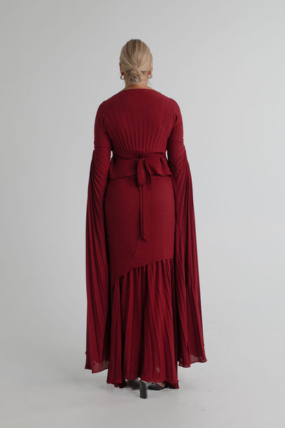 Back view of the Georgia Hardinge Waterfall merlot gown showing sunray pleating, waist tie and sweeping long sleeves.
