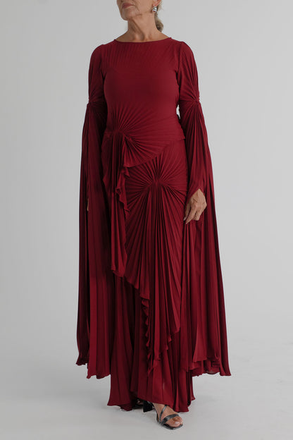 Georgia Hardinge Waterfall merlot pleated maxi gown with long draped sleeves, gathered waist and flowing full-length skirt.

