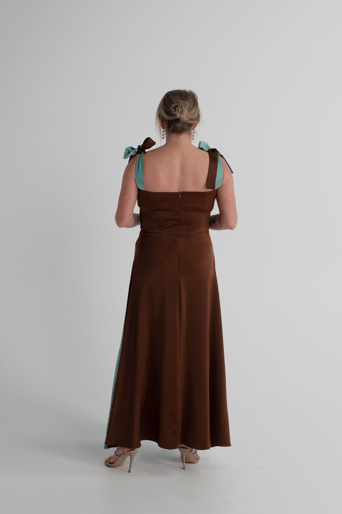 Back view of the IQ Collection Carmen Midi showing the chocolate fitted bodice, aqua tie straps and contrasting flowing skirt.
