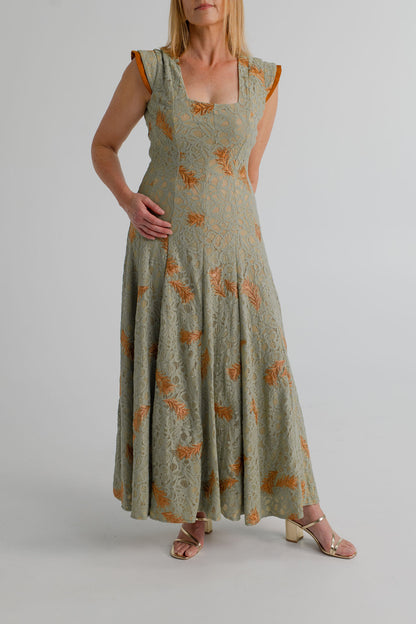Detail view of the IQ Collection Rose Maxi showing the sage floral lace, copper embroidery, square neckline and structured shoulder trim.
