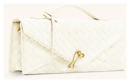 Angled side view of JW Pei Celeste ivory woven envelope top handle bag showing the structured profile and gold-tone closure. 
