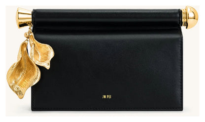 JW Pei Holly black embellished clutch with sculptural gold-tone leaf pendant and bar detail, front view. 

