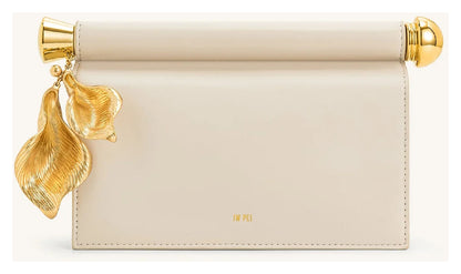 JW Pei Holly cream embellished clutch with sculptural gold-tone leaf pendant and bar detail, front view. 
