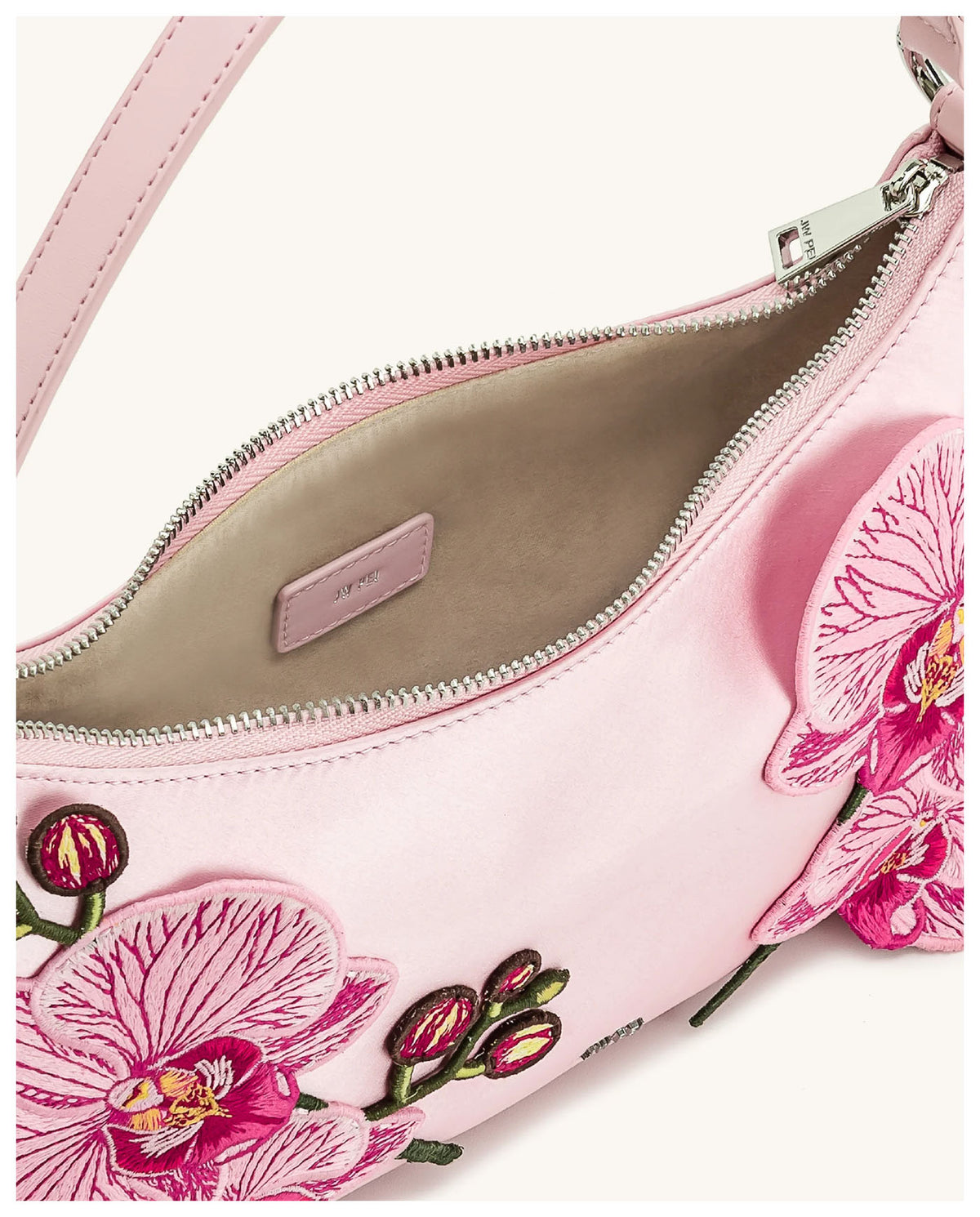 Open view of JW Pei Lily pink orchid embroidered shoulder bag showing the zip closure and light interior. 
