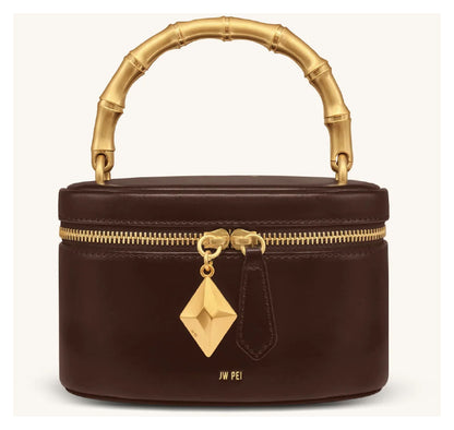 JW Pei Natalie dark brown handle bag with gold-tone bamboo-style top handle, geometric pendant and zip closure, front view. 
