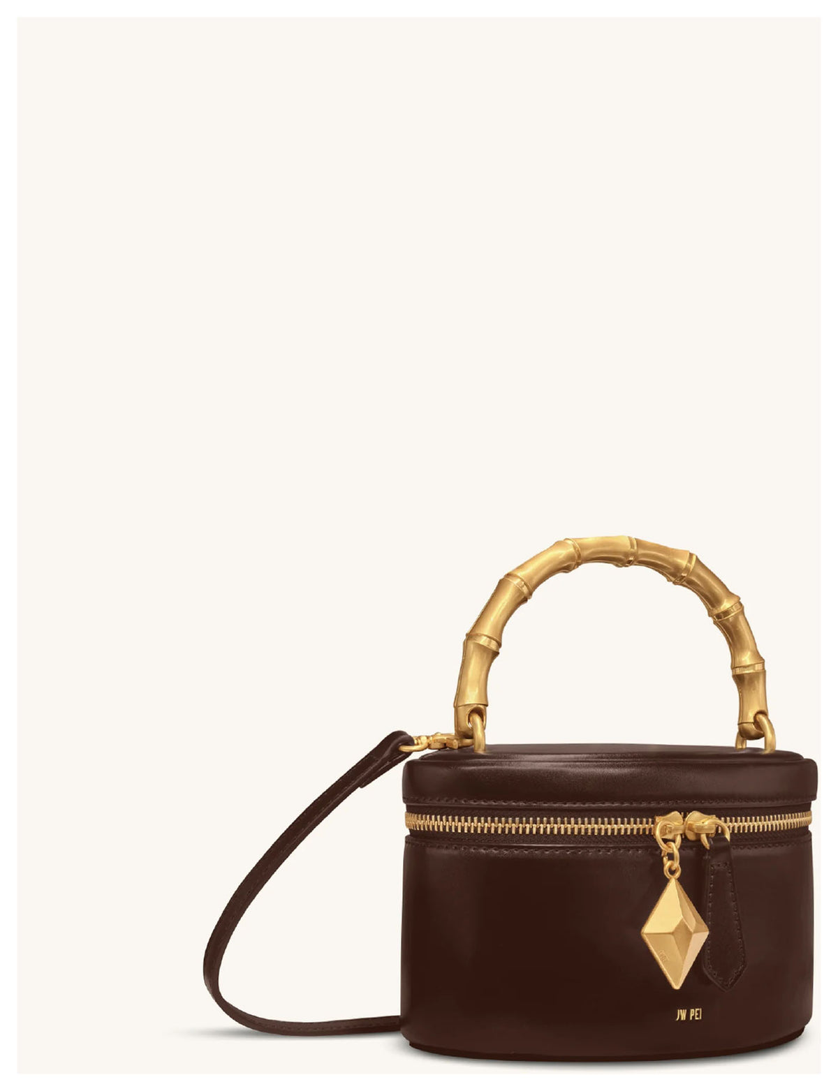 JW Pei Natalie dark brown handle bag with gold-tone bamboo-style handle, geometric pendant and detachable shoulder strap, angled side view. 
