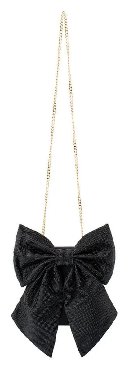 Olga Berg Drew black crystal bow bag with oversized embellished bow and short gold-tone chain handle, front view. 
