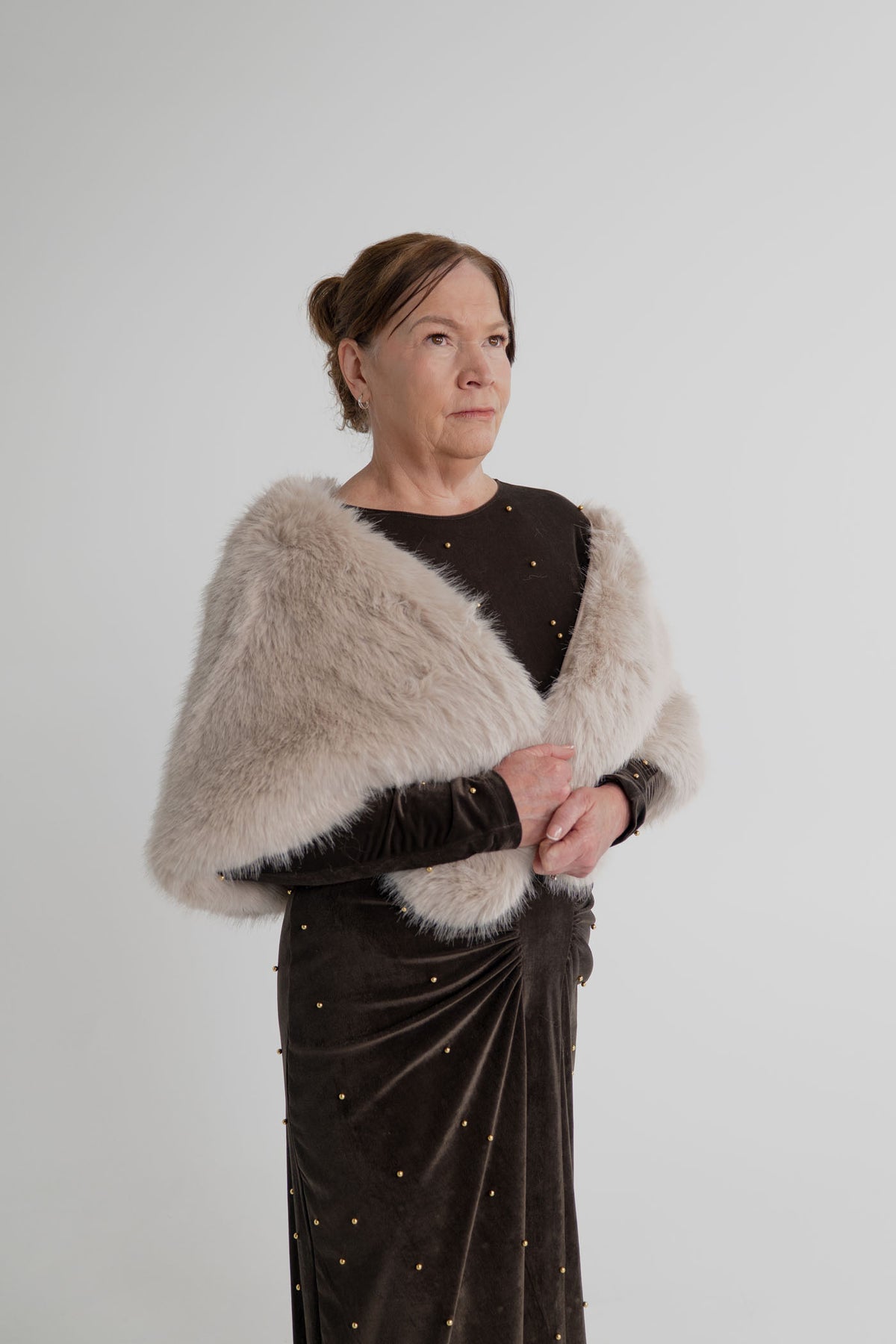 One Fell Swoop Lucent Iron Maiden dark bronze maxi dress styled with the Unreal Fur Yasmine almond faux fur wrap.
