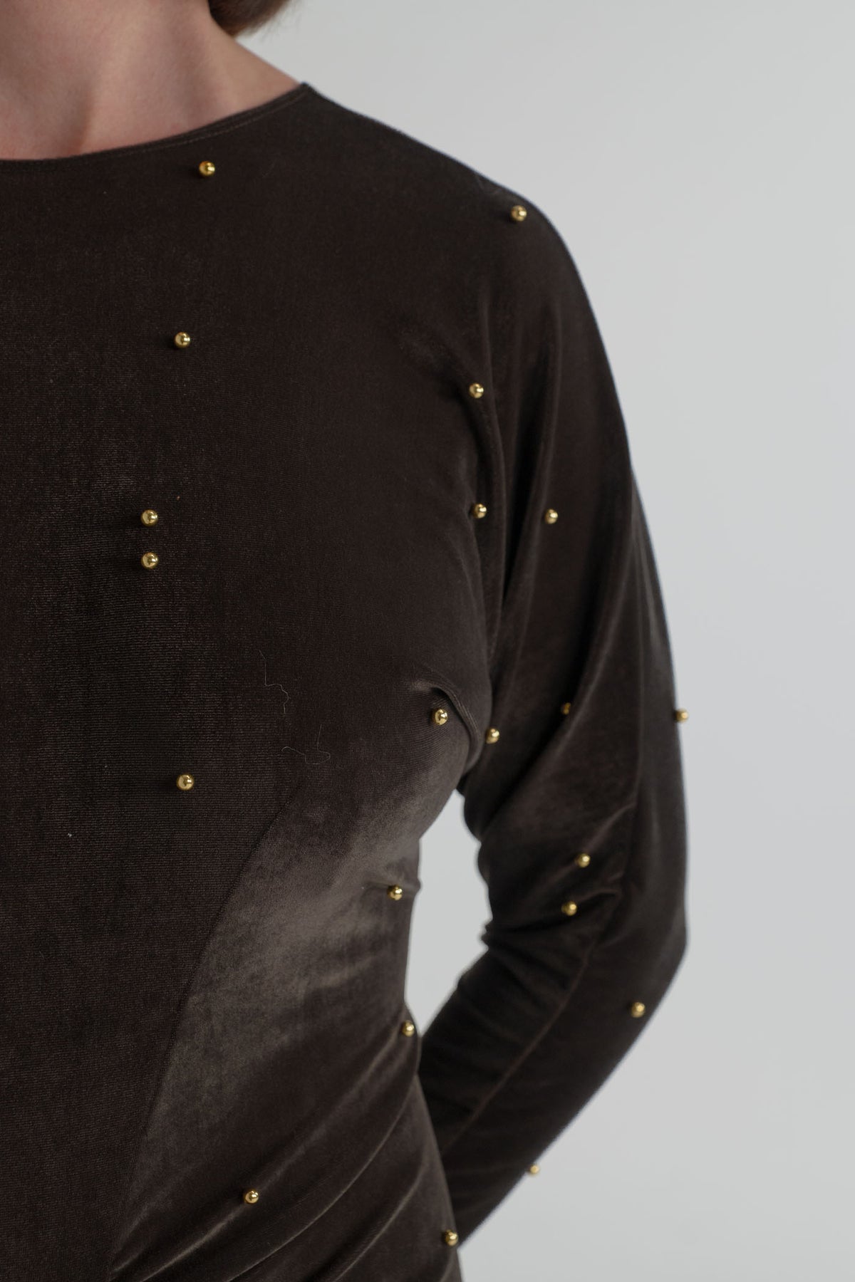 Close-up of the One Fell Swoop Lucent Iron Maiden showing dark bronze velour, long sleeves and scattered gold pearl detailing across the bodice.
