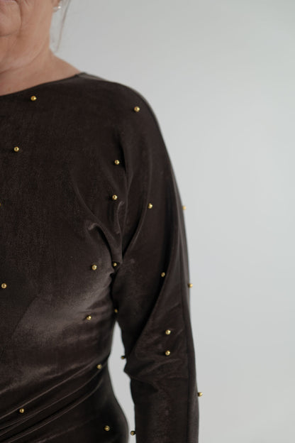One Fell Swoop Lucent Iron Maiden dark bronze velour maxi dress with long sleeves, sculptural ruched waist and scattered gold pearl detailing.
