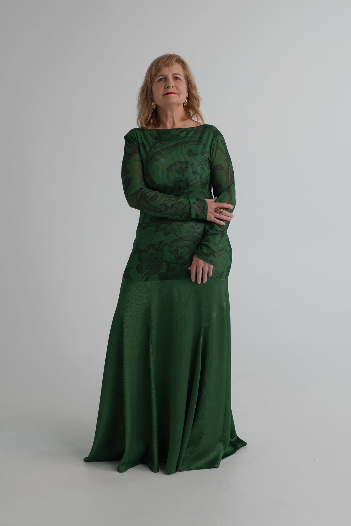 Front detail of the One Fell Swoop New Order deep green gown showing the printed mesh bodice and softly flared satin skirt.
