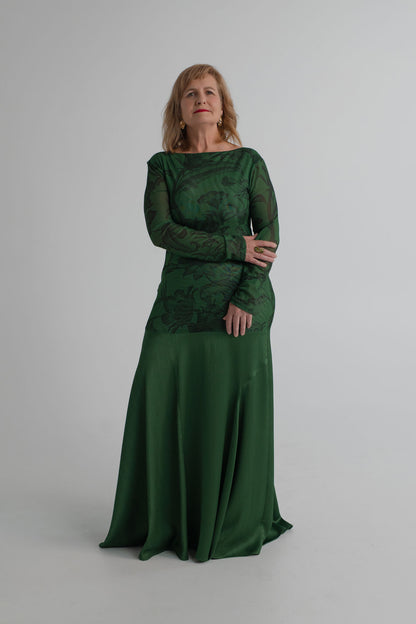 Front detail of the One Fell Swoop New Order deep green gown showing the printed mesh bodice and softly flared satin skirt.
