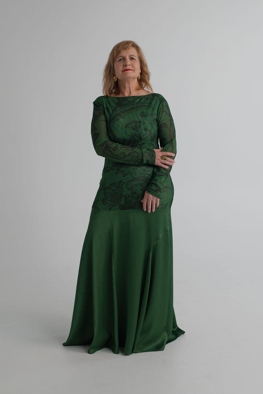 Front detail of the One Fell Swoop New Order deep green gown showing the printed mesh bodice and softly flared satin skirt.
