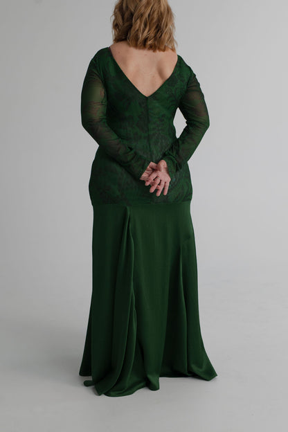 Back view of the One Fell Swoop New Order deep green floral gown showing the V-back, fitted sheer sleeves and flowing full-length skirt.
