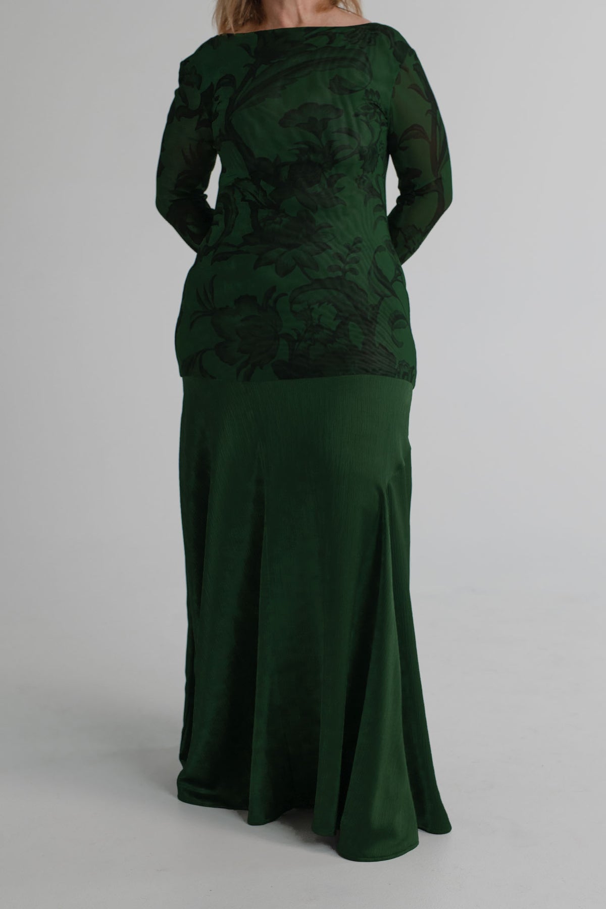 Front detail of the One Fell Swoop New Order deep green gown showing the printed mesh bodice and softly flared satin skirt.
