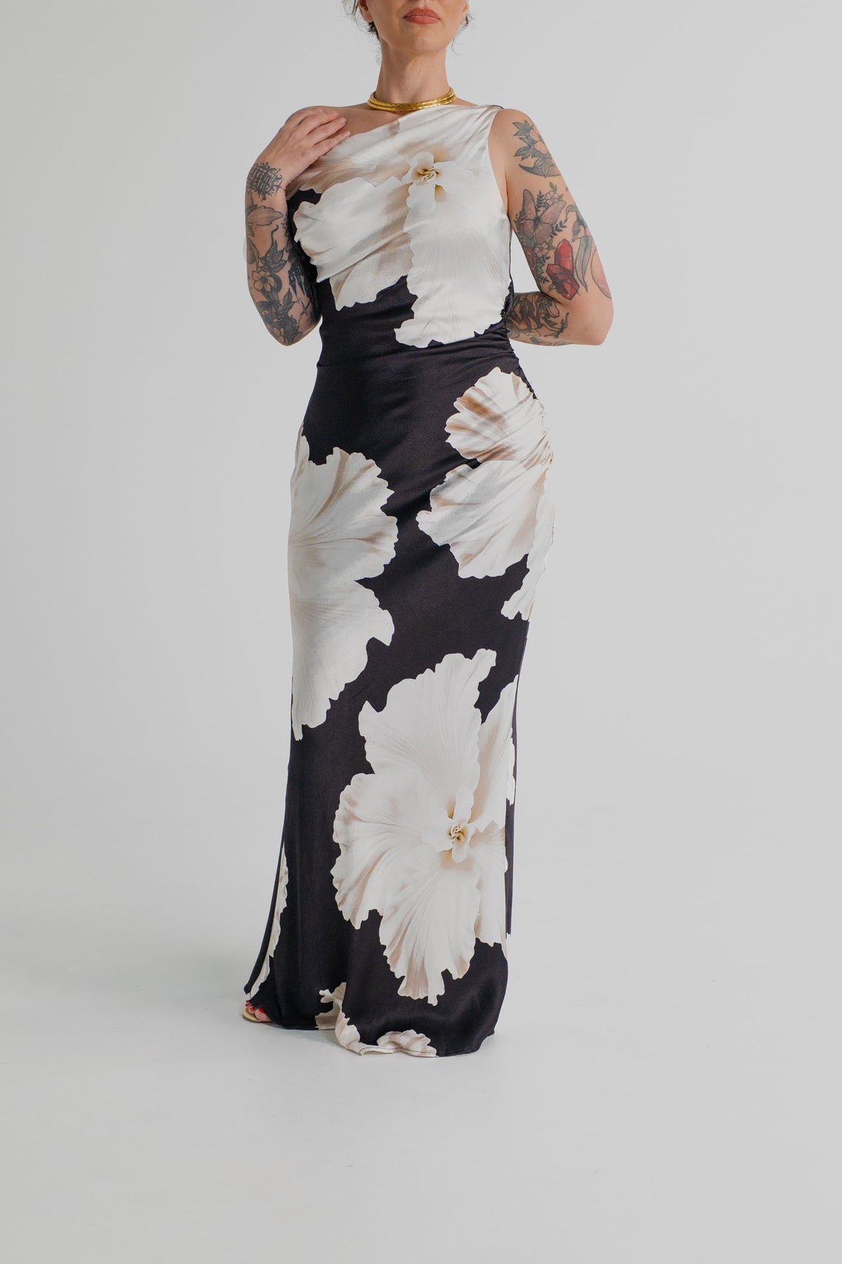 Pasduchas Finley Midnight Bloom black and ivory floral one-shoulder satin maxi dress with soft gathering and fitted column silhouette.
