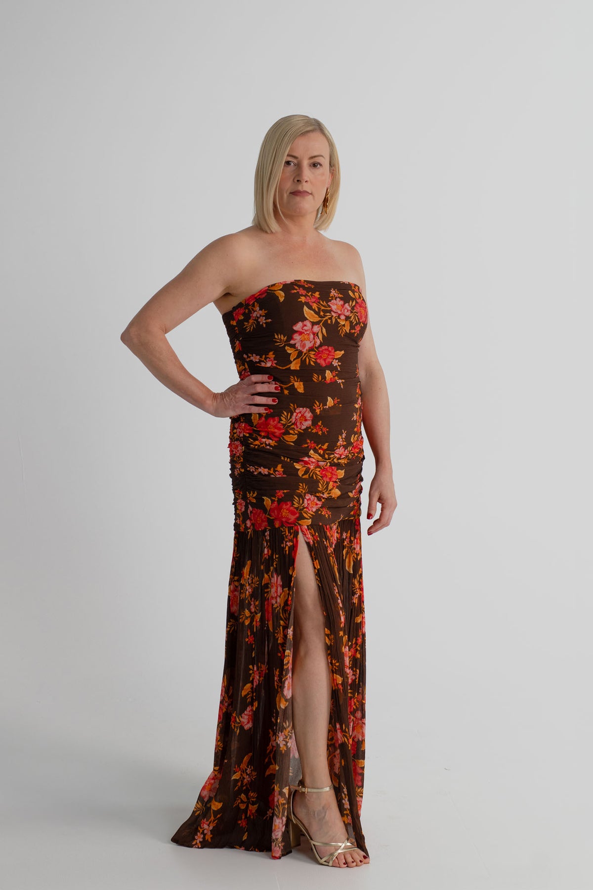 Pasduchas Wren chocolate floral strapless maxi dress with softly gathered fitted bodice, flowing skirt and side-front split.

