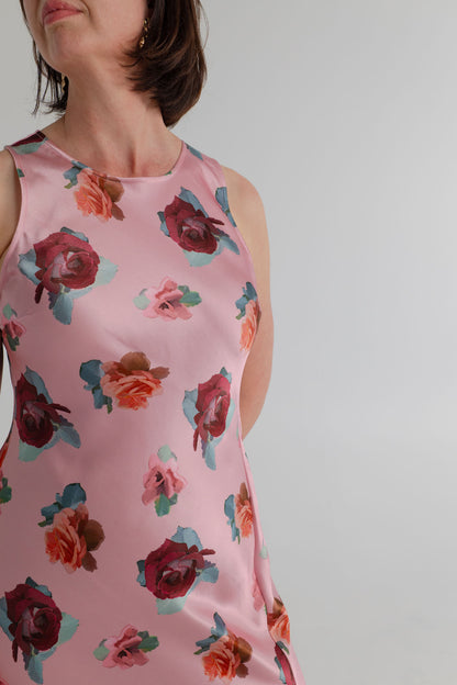 Close-up of the SABA Bettina Maxi Dress showing the soft pink satin, multicolour rose print and clean sleeveless neckline. 
