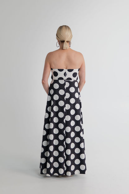 Back view of the Sonya Moda Milano Gown with strapless bodice, fitted waist and full-length black skirt with oversized white polka dots. 
