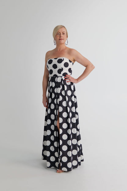 Sonya Moda Milano Gown in black and white polka dot, featuring a strapless fitted bodice, defined waist and flowing full-length skirt. 
