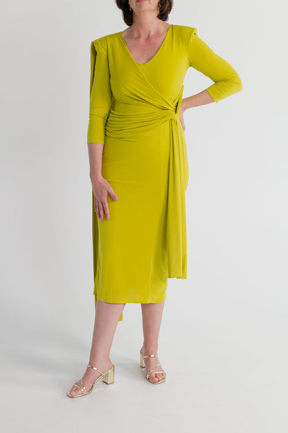 Front detail of the Strena Barbara Midi Dress in chartreuse showing the V neckline, three-quarter sleeves and gathered wrap-style waist.

