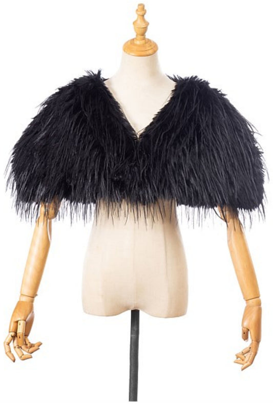 The Two Mrs Grenvilles black faux fur shrug on a mannequin showing the cropped silhouette, open front and long-pile texture. 
