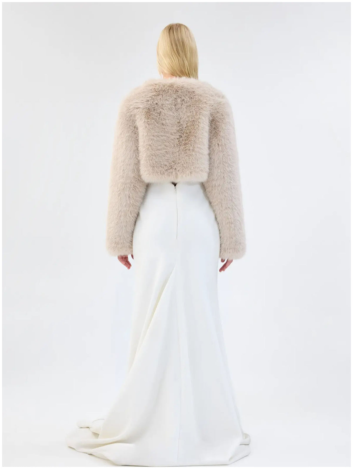 Back view of Unreal Fur Empress almond faux fur jacket showing the cropped length, plush texture and long sleeves. 

