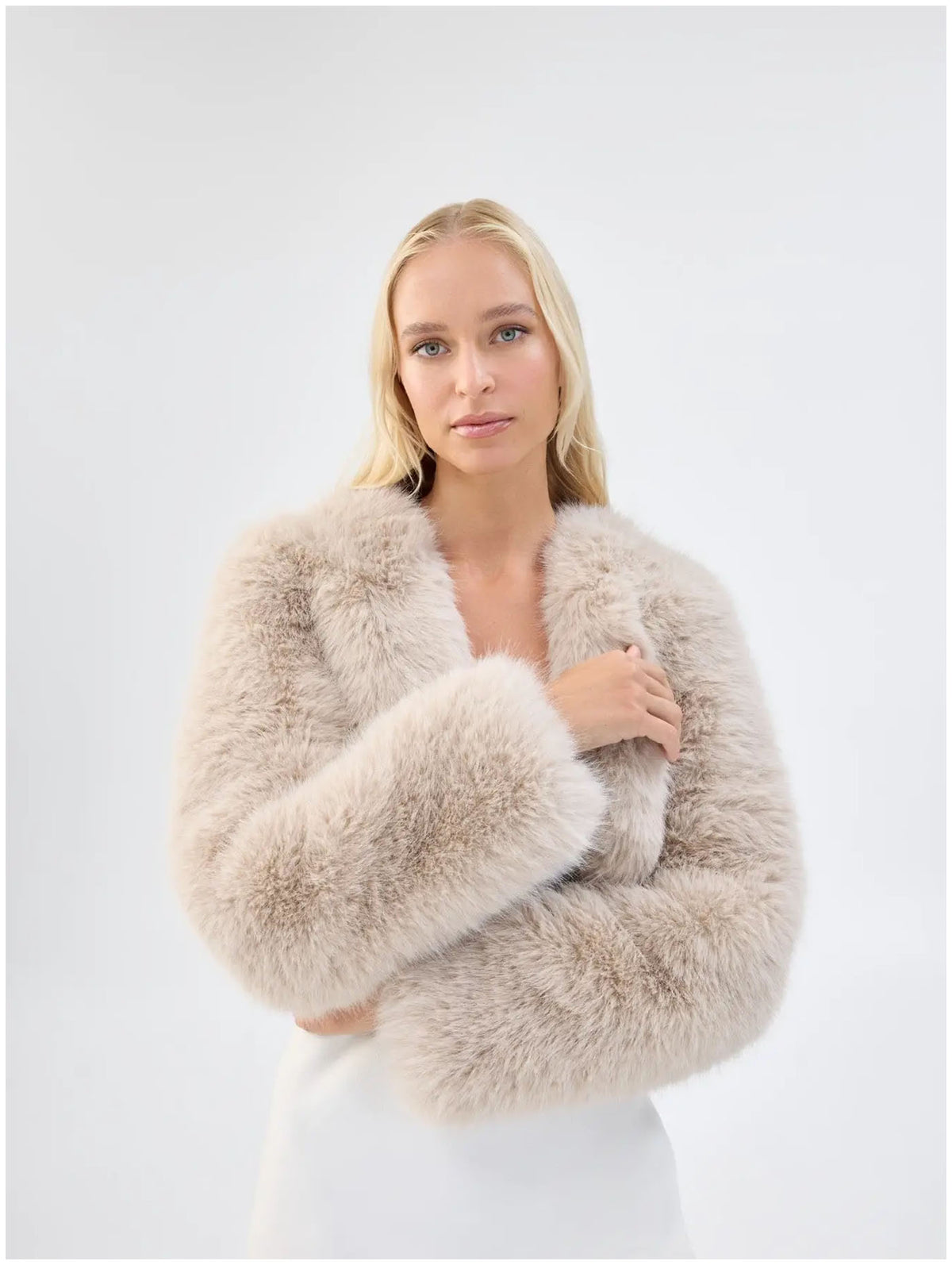 Close front view of Unreal Fur Empress almond faux fur jacket showing the plush texture and cropped open-front shape. 
