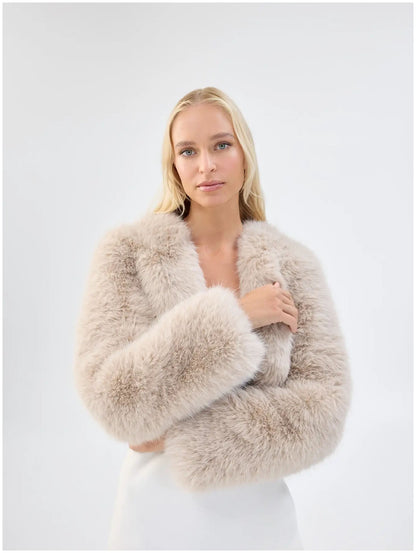 Close front view of Unreal Fur Empress almond faux fur jacket showing the plush texture and cropped open-front shape. 
