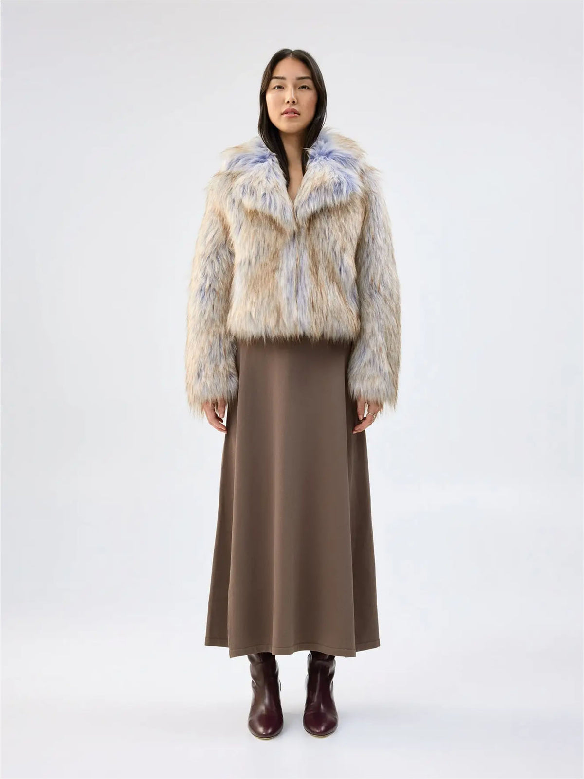 Front view of Unreal Fur Harmony Purple Coyote faux fur jacket showing the plush collar, long sleeves and multitone cream, tan and soft purple faux fur. 

