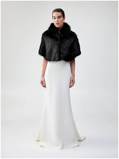 Front view of Unreal Fur Nord Cape in black showing the cropped cape silhouette, high collar and plush long-pile faux fur finish. 
