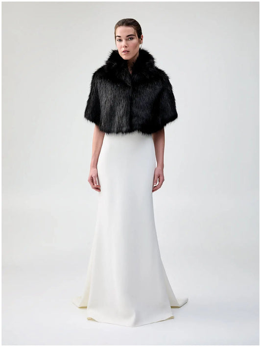 Front view of Unreal Fur Nord Cape in black showing the cropped cape silhouette, high collar and plush long-pile faux fur finish. 
