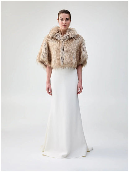 Front view of Unreal Fur Nord Cape in natural showing the cropped cape silhouette, high collar and soft long-pile faux fur finish. 
