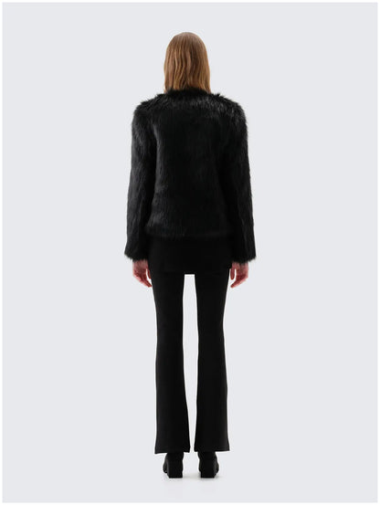 Back view of Unreal Fur Unreal Dream black faux fur jacket showing the straight hip-length silhouette, long sleeves and smooth plush texture. 
