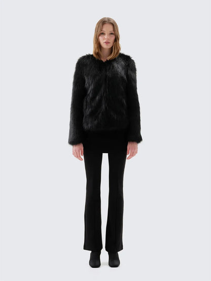Back view of Unreal Fur Unreal Dream black faux fur jacket showing the straight hip-length silhouette, long sleeves and smooth plush texture. 
